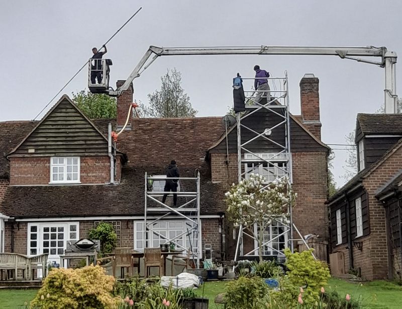 The Roof Moss Cleaners using cherry picker and scaffolding to clean roof safely and professionally in Melbourn, Cambridgeshire